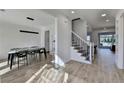 Spacious dining room with contemporary lighting, adjacent to stairs, and views of the home's interior at 10683 Glenleigh Dr, Johns Creek, GA 30097