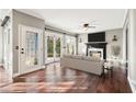 Bright living room featuring hardwood floors, a fireplace, and a door to the backyard at 160 Deer Cliff Cv, Lawrenceville, GA 30043