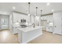 Bright kitchen with stainless steel appliances, white cabinets, and quartz countertops at 5711 Tillman Way, Powder Springs, GA 30127
