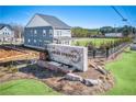 Charming two-story home in Adler Springs neighborhood with manicured lawn and community sign at 5711 Tillman Way, Powder Springs, GA 30127