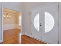 Welcoming entryway showcasing hardwood floors and view into the dining room at 305 Hembree Grove Trce, Roswell, GA 30076