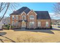 Stately home exterior with mature landscaping and stone facade at 305 Hembree Grove Trce, Roswell, GA 30076