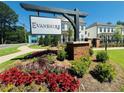 Landscaped entrance to Evanshire community with colorful flowerbeds, green bushes, and a prominent sign at 3187 Moor View Rd # 37, Duluth, GA 30096