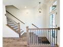 The staircase features wood handrails, black metal balusters, and bright lighting at 3187 Moor View Rd # 37, Duluth, GA 30096