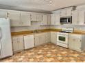 Traditional kitchen featuring ample cabinet space, a stainless steel microwave, and essential appliances at 3980 Bayside Cir, Atlanta, GA 30340