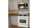 Close-up view of the kitchen range and microwave, highlighting the functional layout and design at 3980 Bayside Cir, Atlanta, GA 30340