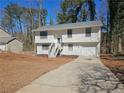 Inviting home featuring a driveway, white siding, and a neatly maintained front yard at 434 Ridgetop Nw Dr, Acworth, GA 30102