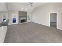 Spacious living room with vaulted ceiling, fireplace, and plush carpeting at 1280 Pinyon Pl, Lawrenceville, GA 30043