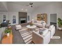 Bright living room boasts neutral paint, modern furniture, fireplace, and ample natural light at 1280 Pinyon Pl, Lawrenceville, GA 30043