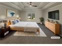 Bright main bedroom with a tray ceiling and large window overlooking the backyard at 1280 Pinyon Pl, Lawrenceville, GA 30043