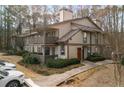 Inviting condo building featuring a well-kept exterior, second story balconies, and ample parking at 707 Woodcliff Dr, Atlanta, GA 30350