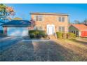 Lovely two-story brick home with manicured front yard and attached garage at 895 Smoketree Dr, Tucker, GA 30084