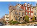 Attractive townhouse featuring manicured landscaping, brick accents, and a welcoming entrance at 142 Perimeter Walk, Atlanta, GA 30338