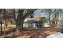 View of the exterior featuring a cute front yard, surrounded by mature trees at 2224 Elizabeth Se Ave, Smyrna, GA 30080