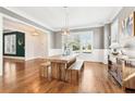 Elegant dining room featuring a wooden dining table, bench seating, and natural light from large windows at 2685 Grady Se St, Smyrna, GA 30080