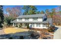 Beautiful two-story home with neutral siding, dark shutters and a manicured lawn at 1285 Oakhaven Dr, Roswell, GA 30075