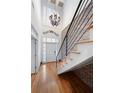 Elegant foyer with a grand staircase, chandelier, and beautiful hardwood floors at 1605 Ridenour Nw Pkwy, Kennesaw, GA 30152