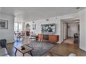 Living room showcasing hardwood floors and open-concept design leading to the dining area at 3435 Kingsboro Ne Rd # 1701, Atlanta, GA 30326