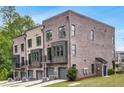 Brick townhomes showcasing private garage entries and sleek modern design at 901 Echo Park Dr, Suwanee, GA 30024
