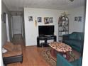 Functional living room with neutral walls, hardwood floors, and a comfortable seating arrangement at 998 Sparks Sw St, Atlanta, GA 30310