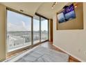 Sunlit living room features floor-to-ceiling windows and private balcony access with beautiful city views at 361 17Th Nw St # 1021, Atlanta, GA 30363