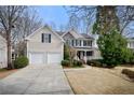 View of home from the street, highlighting the two-car garage and landscaped front yard at 1810 Valley Brook Dr, Alpharetta, GA 30005