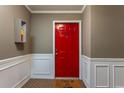 Inviting entryway featuring a bright red door, white wainscoting, and a cheerful welcome mat at 3529 Essex Ave # 75, Atlanta, GA 30339