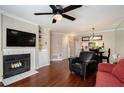 Cozy living room with hardwood floors, fireplace, built-in shelving, and an open floor plan at 3655 Habersham Ne Rd # 226-A, Atlanta, GA 30305