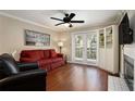 Comfortable living room with hardwood floors, a fireplace, built-in shelves, and French doors at 3655 Habersham Ne Rd # 226-A, Atlanta, GA 30305