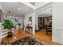 Grand foyer with hardwood floors, a large rug, and an ornate entry to a room with a piano at 730 Glenferry Trl, Atlanta, GA 30328