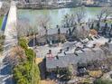 A top-down view of the property with a bridge and river in the background with an arrow to this property at 1115 Riverbend Club Se Dr, Atlanta, GA 30339
