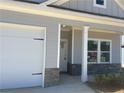 Detailed view of the home's entrance showcasing stone accents and a white-trimmed front porch at 121 Sunflower Cir, Cartersville, GA 30121