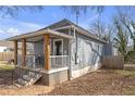 Rear exterior featuring charming covered porch, well-maintained siding and steps that lead to the cozy backyard at 1146 Sims Sw St, Atlanta, GA 30310