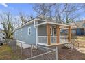 Charming home exterior featuring a cozy covered porch, a secure fence, and freshly painted siding at 1146 Sims Sw St, Atlanta, GA 30310