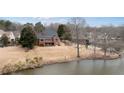 View of backyard from the lake, showing large lot, mature trees and multi-level patio at 426 Lakestone Dr, Suwanee, GA 30024