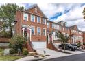 Attractive brick townhomes featuring attached garages, well-manicured lawns, and patriotic decor at 2471 Bridlewood Se Dr # 8, Atlanta, GA 30339