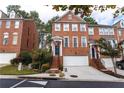 Charming three-story brick townhome with an attached garage and well-maintained landscaping at 2471 Bridlewood Se Dr # 8, Atlanta, GA 30339