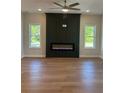 Bright living room with an electric fireplace, accent wall and natural light through two windows at 1923 Cassia Aly, Kennesaw, GA 30144