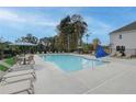 Community pool with lounge chairs, umbrellas and trees in a neighborhood at 1923 Cassia Aly, Kennesaw, GA 30144