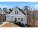 Two-story home with light siding, attached garage, and ample natural light at 3175 Tackett Rd, Douglasville, GA 30135