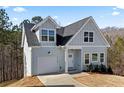 Two-story home featuring light siding, an attached garage, and driveway at 3175 Tackett Rd, Douglasville, GA 30135