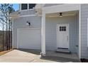 Attached garage and front door of a light blue two-story home at 3175 Tackett Rd, Douglasville, GA 30135