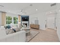 Inviting living room with large windows, a cozy fireplace, and modern furnishings, creating a relaxing atmosphere at 628 Topsail Drive Pkwy, Villa Rica, GA 30180