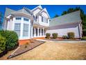 Beautiful two-story home featuring well-maintained landscaping and a welcoming front entrance at 2003 Hubbard Ct, Villa Rica, GA 30180