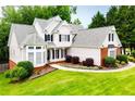 Elegant two-story home with manicured lawn and beautiful architectural details at 2003 Hubbard Ct, Villa Rica, GA 30180