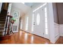 Grand foyer entrance featuring hardwood floors and a stunning front door with sidelights at 2003 Hubbard Ct, Villa Rica, GA 30180