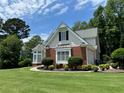 Charming two-story home features a well-manicured lawn and inviting curb appeal with black shutters at 2003 Hubbard Ct, Villa Rica, GA 30180