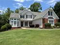 Charming two-story home features a well-manicured lawn and inviting curb appeal with black shutters at 2003 Hubbard Ct, Villa Rica, GA 30180