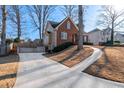 An appealing home with a long driveway and a combination of brick and siding at 2385 Cape Courage Way, Suwanee, GA 30024