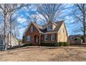 Well-maintained home featuring a brick facade, complemented by neutral siding and professionally landscaped grounds at 2385 Cape Courage Way, Suwanee, GA 30024
